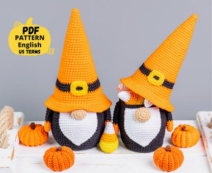Two crochet Halloween-themed gnomes with pumpkins on a gray background