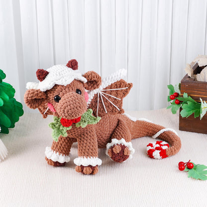 Crocheted dog toy with a Santa hat, scarf, and candy canes on a white background